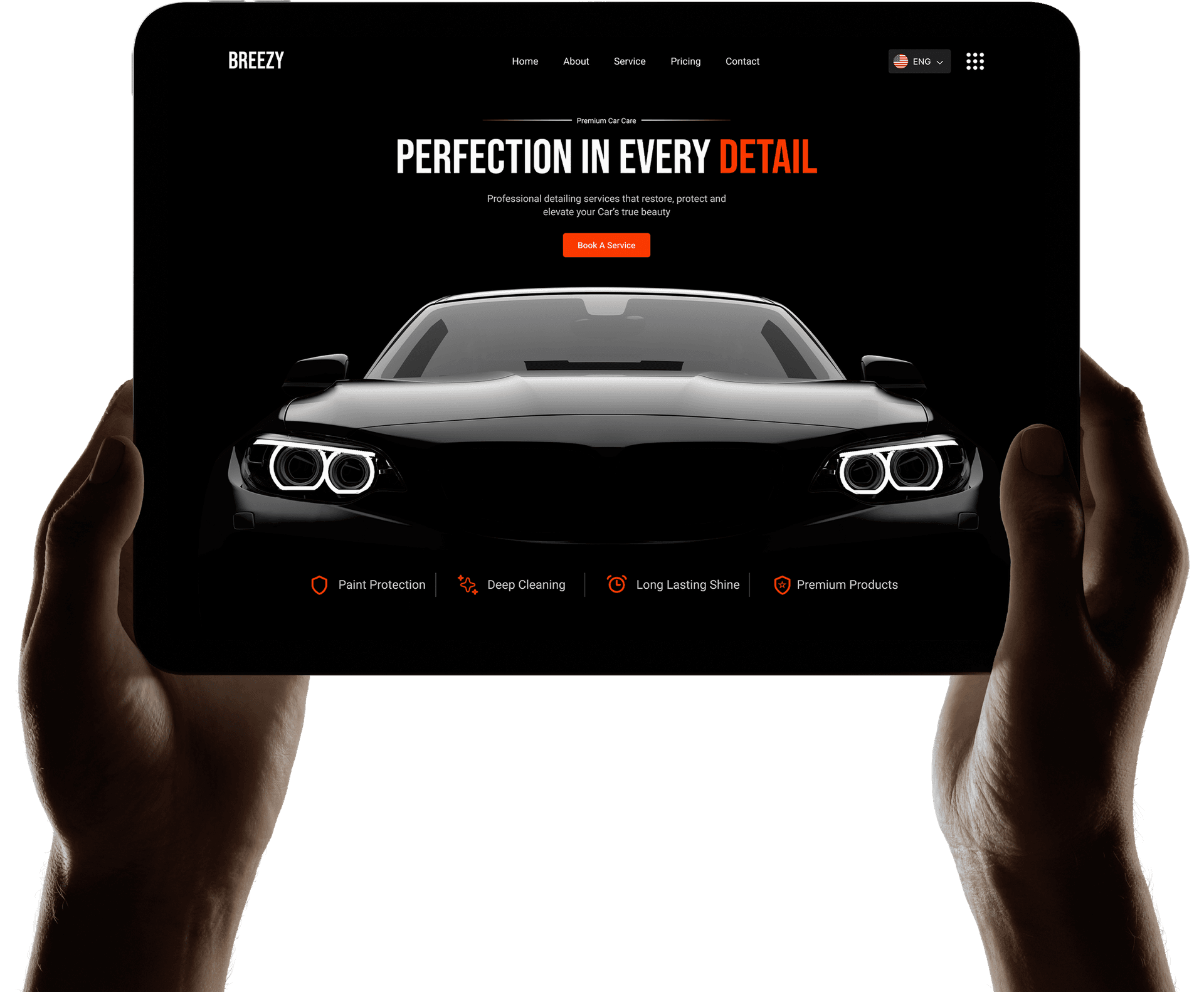 Hands holding tablet displaying Breezy car detailing website with premium car care services